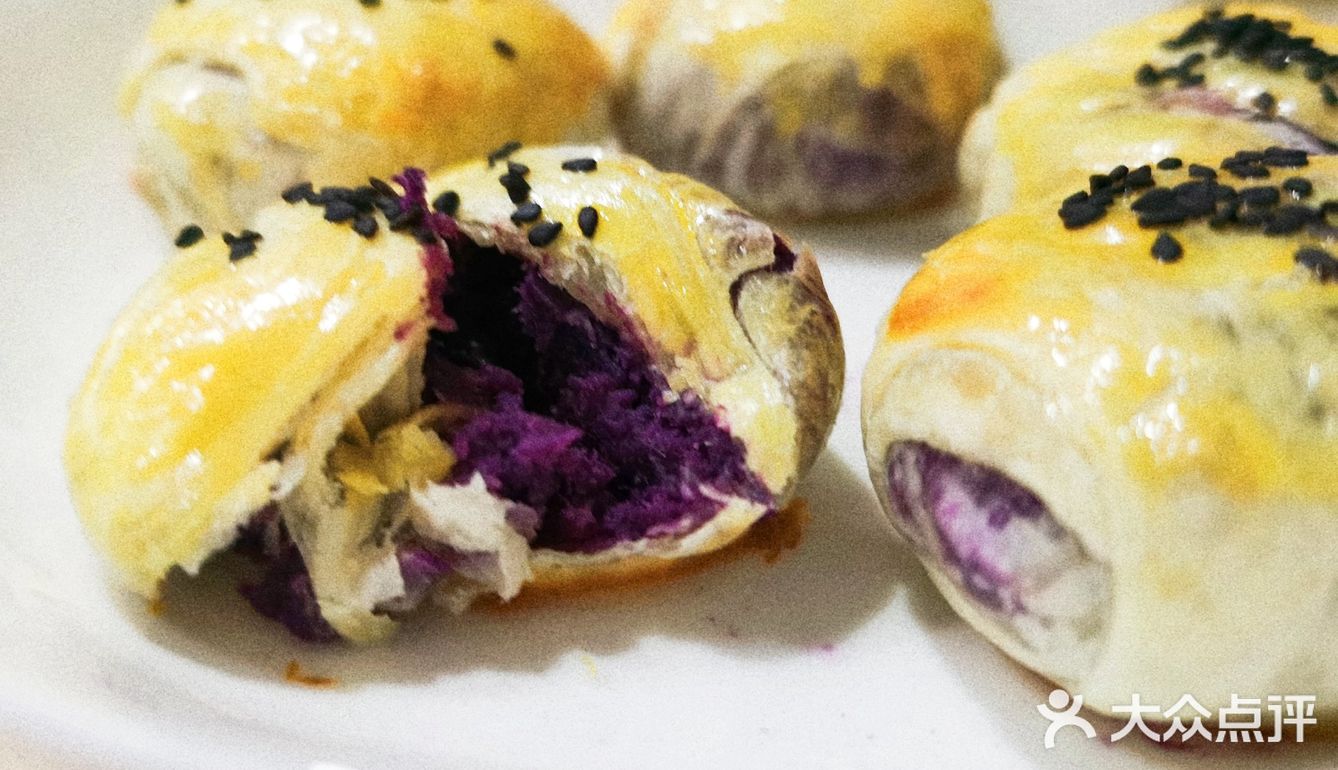 手抓饼分5块卷入香肠，涂上蛋黄液和黑芝麻