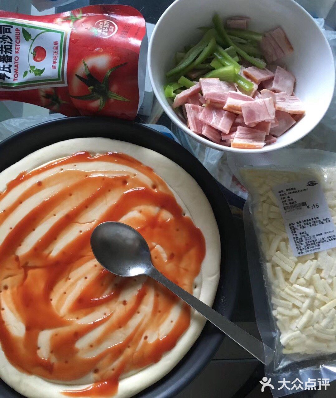 放入饼胚，刷上番茄酱或者甜辣酱，准备配料