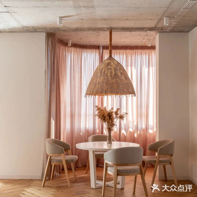 餐厅位于落地窗旁，光线透过暖色窗帘照入室内