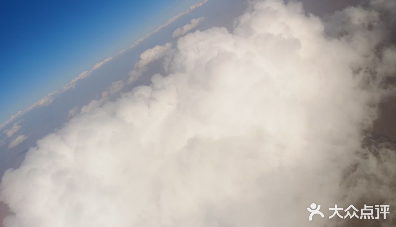 天空很蓝，几朵白云就像是画上去似的，天空和白云都很干净