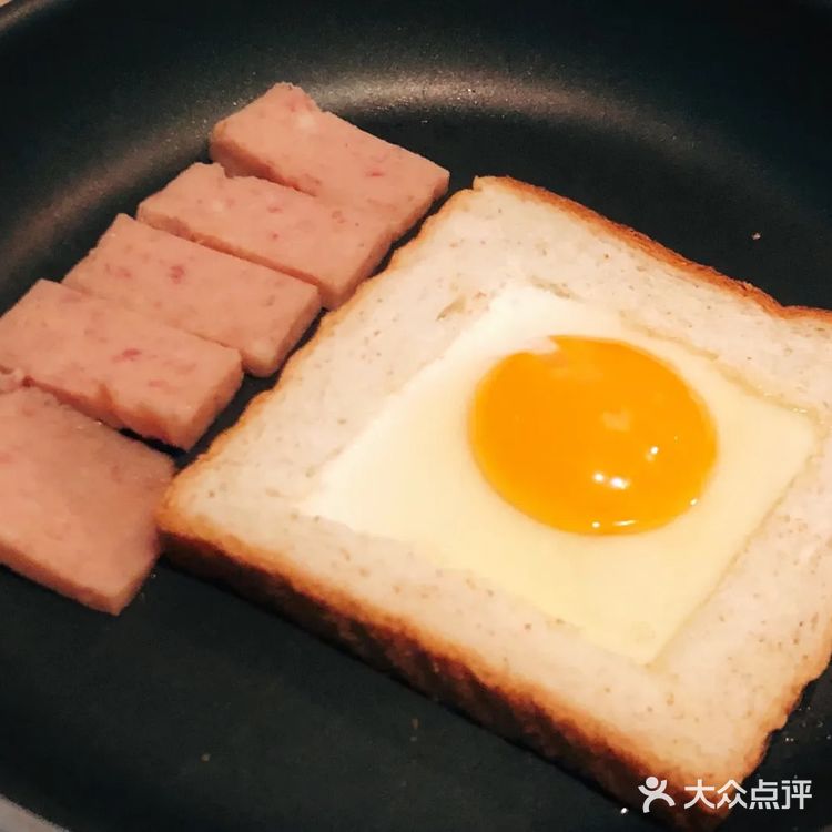 放入挖空的吐司，把鸡蛋打入吐司框里面