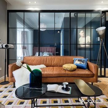 焦糖色的皮沙发,沙发两侧分别是投影仪支架、落地灯