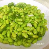 再放入青椒，炒出辣味，接着倒入毛豆，翻炒均匀