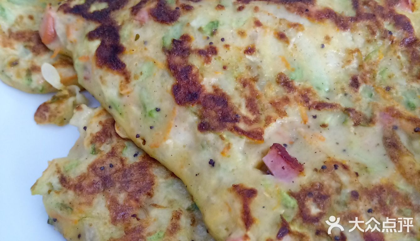 制作方法。先把鸡蛋打散加上面，把西葫芦擦成丝儿